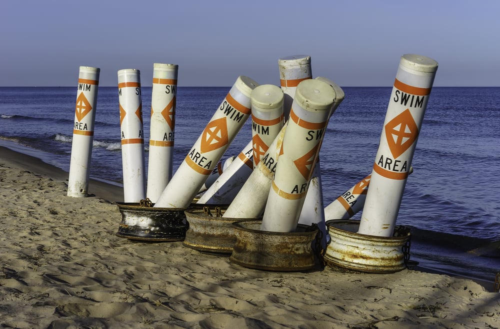 Tall buoys for marking boundaries of safe swimming areas off beach along Lake Michigan in spring before the arrival of beachgoers